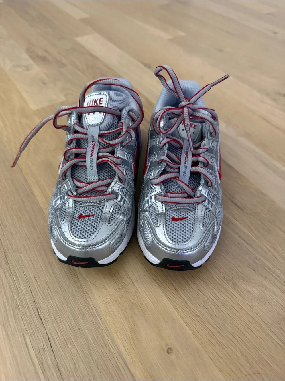 Nike Kids Silver Sneakers with Red Swoosh